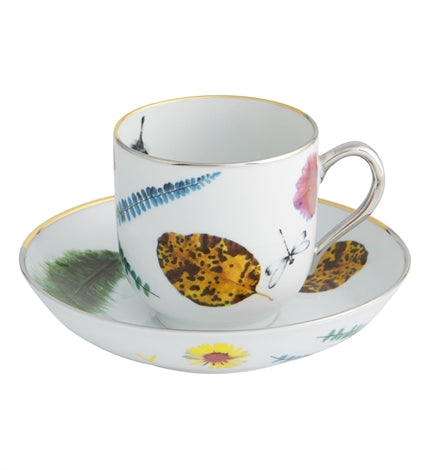 Vista Alegre | Lacroix - Caribe Tea Cup And Saucer features a white porcelain design with gold trim, botanical motifs, and a dragonfly, exemplifying tropical elegance.