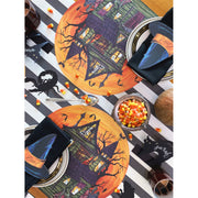 Hester & Cook Die-Cut Haunted House Placemat on table with candy corn and utensils, perfect for Halloween-themed dining.