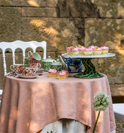 Vista Alegre | The Meaning Espresso Cup and Saucer set with floral design, displayed on a pink tablecloth with cupcakes and a teapot.