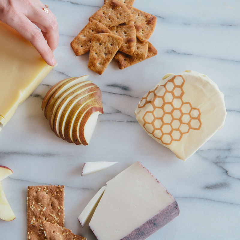 Bee's Wrap - Cut-to-Size Roll - Honeycomb displayed with cheese and crackers on a marble surface, highlighting its reusable, eco-friendly food storage capabilities.