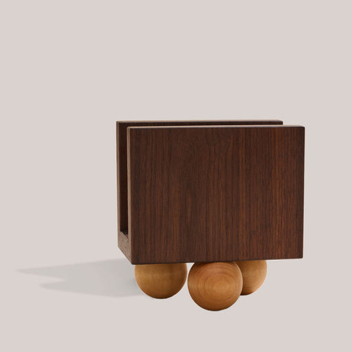 Atelier Saucier | Les Trois Wooden Napkin Holder: Dark walnut panels with birch wood ball feet, perfect for organizing napkins or letters on a tabletop.