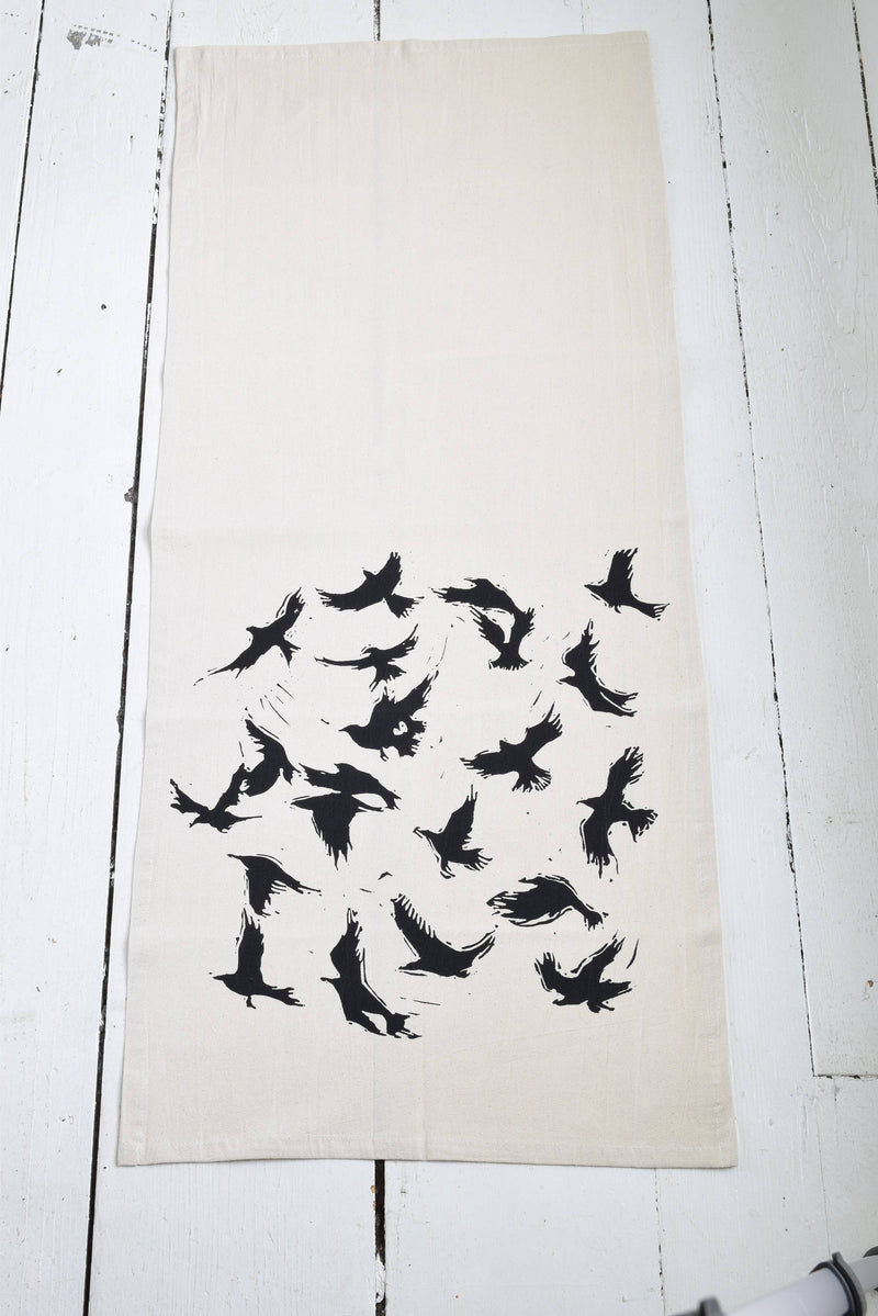 Hearth and Harrow - Organic Cotton Flying Crows Tea Towel showcases black bird silhouettes on eco-friendly fabric, ideal for both kitchen utility and fine dining elegance.