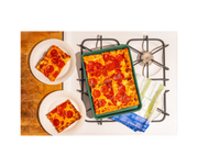 Great Jones | Little Sheet - Pepper shown with a pepperoni pizza, highlighting its compact size and nonstick surface for easy baking or reheating.