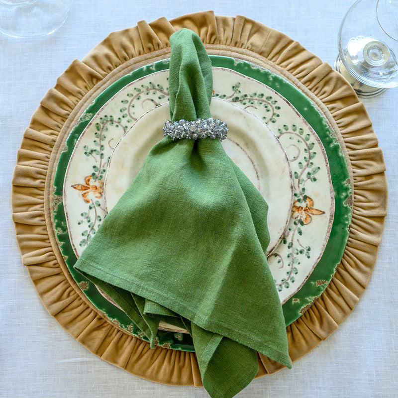 Crown Linen Designs | Washed Linen Napkin Sets - Evergreen elegantly adorns a place setting with a green napkin in a silver ring, enhancing the dinnerware's charm.