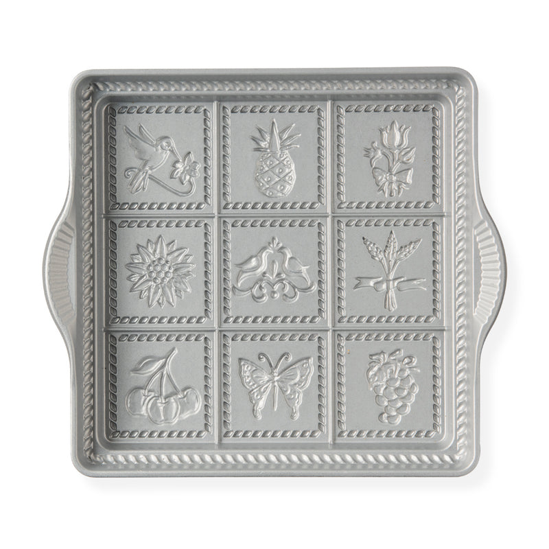 Nordic Ware | English Shortbread Pan, featuring intricate flower and fruit designs, perfect for baking crisp, buttery treats. Silver square tray for elegant presentation.