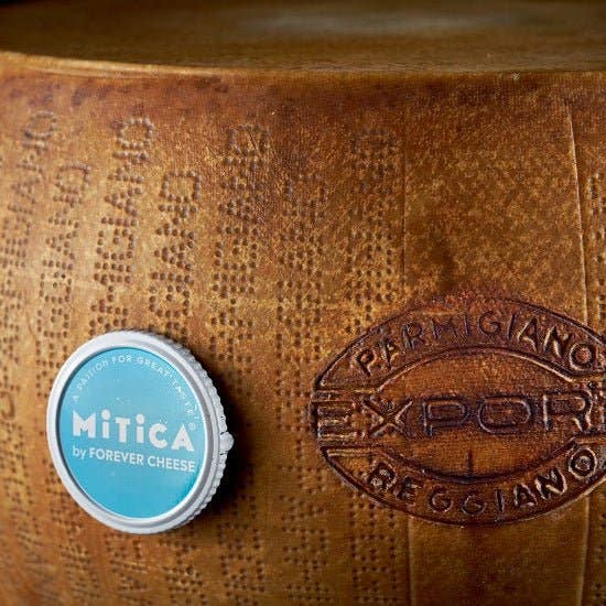 Nicola's Marketplace - Parmigiano Reggiano DOP Mitica® 36 months: 7 Ounces wheel with Mitica label, showcasing authentic Italian cheese with characteristic dotted rind.