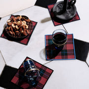 Jubilee Plaid Cocktail Napkins set with mixed nuts, candleholder, and glasses, highlighting festive tableware from Athens Cooks.
