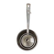 RSVP Mini Funnel Set of 3, stainless steel funnels for precise pouring in kitchens, shown with a ladle and measuring cups.