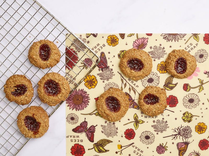 Bee's Wrap - Assorted 3 Pack - Meadow Magic, Plant Based Wax, displayed under oat-based thumbprint cookies cooling on a wire rack.