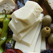 Rebel Cheese - Gruyere Plant Based - 5 oz, served with olives and cheese, ideal for sandwiches and salads. Gluten-free, with nutty, salty flavor.