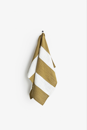 Striped linen tea towel with hanging loop, part of MagicLinen's zero-waste program, designed for kitchen use; soft, absorbent, and eco-friendly.