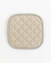 MagicLinen linen pot-holder with quilted detailing and heat-insulating padding, featuring a hanging loop, perfect for stylish and practical kitchen use.