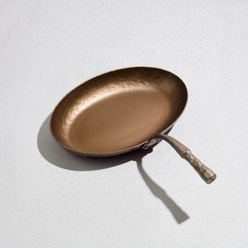 Smithey | The Fish Skillet: Hand-forged hammered-metal frying pan with a long, textured handle, ideal for versatile cooking, inspired by classic French design.