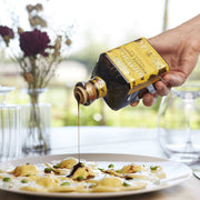 Drizzling Giusti Quarto Centenario Balsamic Vinegar over stuffed pasta, showcasing its rich texture and gourmet pairing, ideal for culinary enthusiasts.