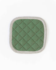 MagicLinen - Linen pot-holder in various colors: Grey blue, featuring quilted detailing, square shape, and a hanging loop, ideal for heat protection in kitchen settings.