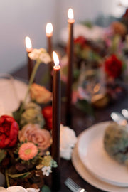 Mo&Co Home - Chestnut | Dipped Beeswax Taper Candles | All Natural: 14 Inch burning elegantly amidst a floral centerpiece, enhancing the table's sophisticated ambiance.