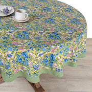 Caravan Home 59 x 86 Jardin Blue & Vert Tablecloth featuring vibrant floral patterns with a white plate and cup, showcasing artisanal craftsmanship.