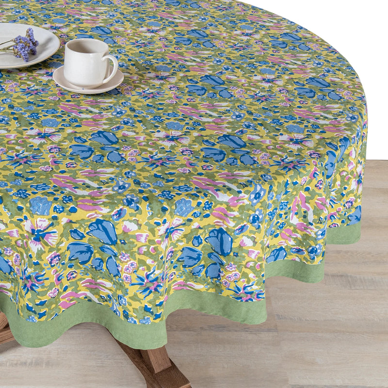 Caravan Home 59 x 86 Jardin Blue & Vert Tablecloth featuring vibrant floral patterns with a white plate and cup, showcasing artisanal craftsmanship.