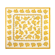 Caravan Home Fig Citrine Tablecloth, 71 x 71, featuring a yellow and white leaf pattern, ideal for adding a touch of elegance to your kitchen decor.