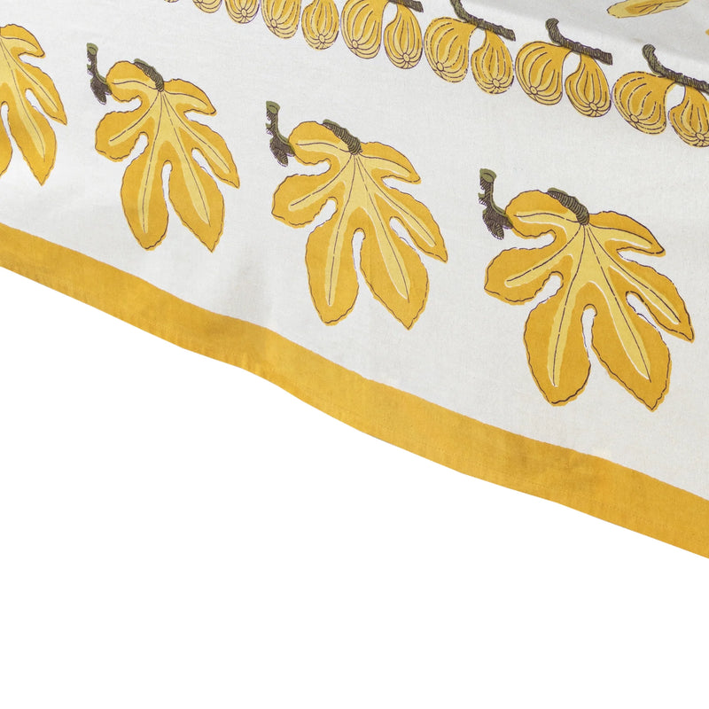 Caravan Home | 59 x 86 Fig Citrine Tablecloth featuring citrine yellow leaves on ivory, handprinted by artisans, perfect for elegant table settings.
