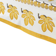 Caravan Home | 71 x 106 Fig Citrine Tablecloth featuring citrine yellow leaves handprinted on ivory linen, perfect for stylish table settings.