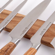 Messermeister | Acacia Magnetic Knife Rack displaying stainless-steel knives with olive-wood handles on a wooden strip, showcasing stylish, accessible kitchen organization.