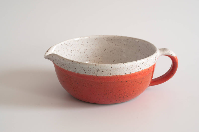 RachaelPots - Salad Dressing Bowl: Pink, a red and white speckled ceramic bowl with a garlic scraper, handle, and pour spout, ideal for dressings and marinades.