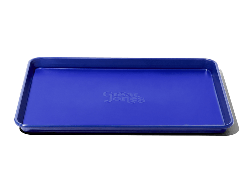 Great Jones | Holy Sheet - Pepper, a versatile blue kitchen tray with a nonstick ceramic coating, ideal for effortless baking and stylish serving.