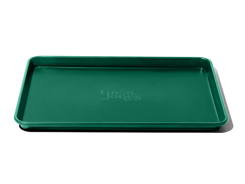 Great Jones | Holy Sheet - Pepper: A versatile half-sized sheet pan with nonstick ceramic coating for easy cleaning, ideal for both baking and serving directly to the table.