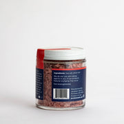Jacobsen Salt Co. - Pinot Noir Salt jar, featuring a label and barcode, offers rich aromatics for enhancing dishes like braised beef and red sauce.