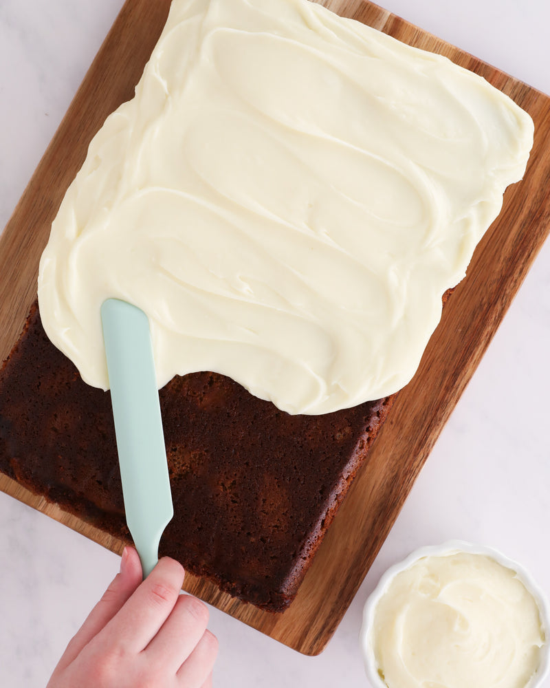 GIR | Ultimate Spreader - Sprinkles being used to smoothly spread frosting on a cake, showcasing its ergonomic design and versatility for various culinary tasks.