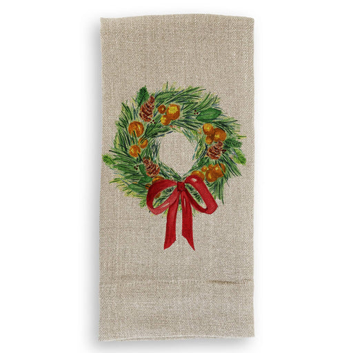 French Graffiti - Christmas Wreath: Natural Guest Towel featuring a painted holiday wreath with pine needles, cones, and orange sprigs, tied with a red ribbon.