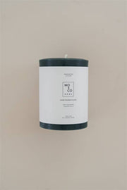 Mo&Co Home - Forest Green 100% Beeswax Pillar Candle, hand-poured, 3x4 inches, displayed with a simple white label highlighting its sustainable and eco-conscious features.