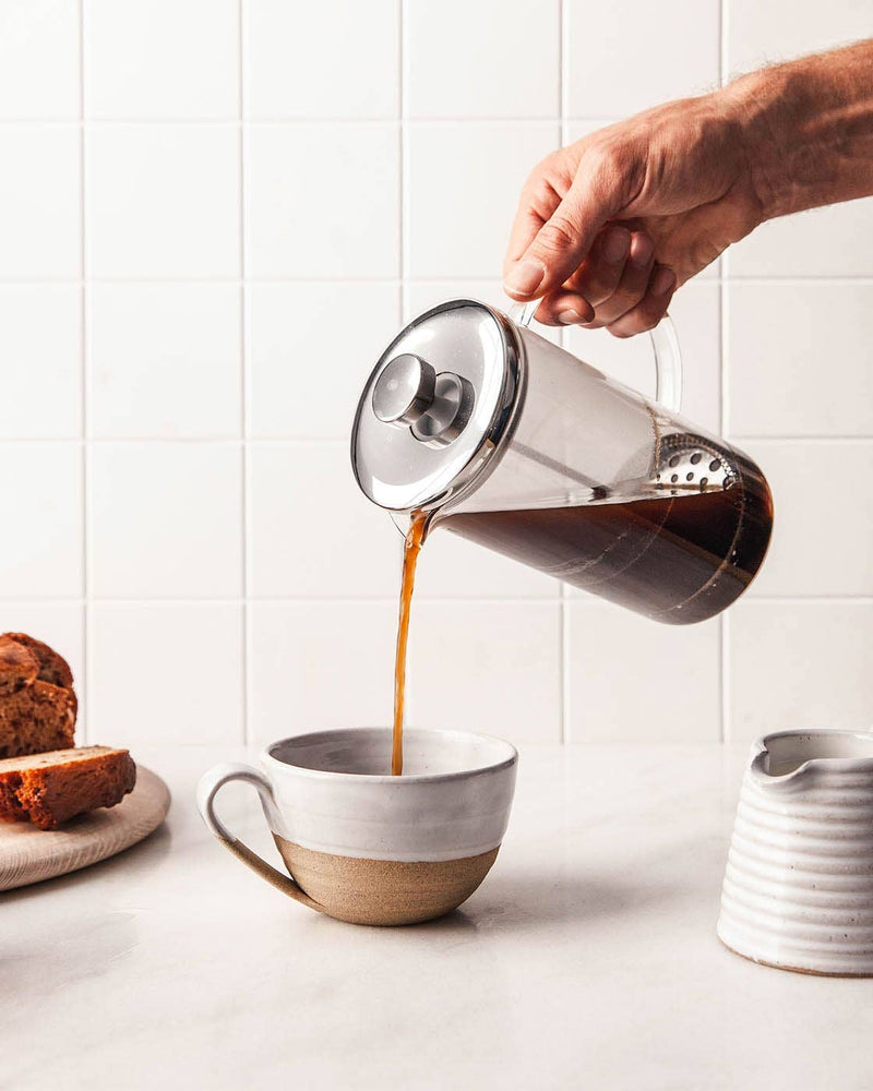 Farmhouse Pottery - Pantry Mug: Large, filled with coffee from a French press, sits beside bread and a cream pitcher on a white countertop.