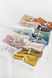 MagicLinen - Set of 2 linen napkins, folded and tied with ribbon, showcasing premium-quality fabric for stylish table decor. Ideal for sustainable, versatile table settings.
