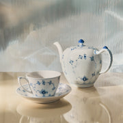 Royal Copenhagen | Blue Fluted Pl Teapot 100cl with intricate blue floral design, featuring a snail shell detail on lid, on light surface.
