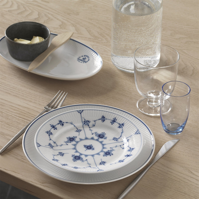 Royal Copenhagen | Blue Fluted Plain Plate, 22cm, elegantly set with matching china bowl, stainless-steel cutlery, and butter dish, enhancing any dinner table.