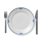 Royal Copenhagen | Princess Plate, 22cm, features a hand-painted blue scalloped border, shown with a fork and knife, embodying classic femininity and elegance.