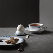 Royal Copenhagen | Princess Plate, 22cm, elegantly holds toast soldiers, showcasing its intricate blue lace border amidst a classic breakfast setting with matching china.