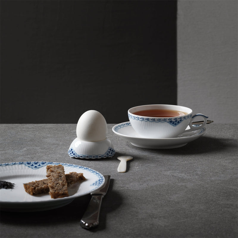 Royal Copenhagen | Princess Plate, 22cm, elegantly holds toast soldiers, showcasing its intricate blue lace border amidst a classic breakfast setting with matching china.
