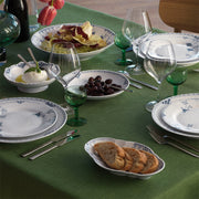 Royal Copenhagen | Princess Plate, 27cm, elegantly set on a green tablecloth with matching porcelain, glassware, and gourmet dishes, embodying classic and refined dining aesthetics.
