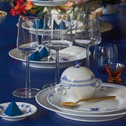 Royal Copenhagen Princess Plate, 27cm, with hand-painted lace and fish scale design, elegantly set with matching porcelain and gold-handled spoon on a formal table setting.