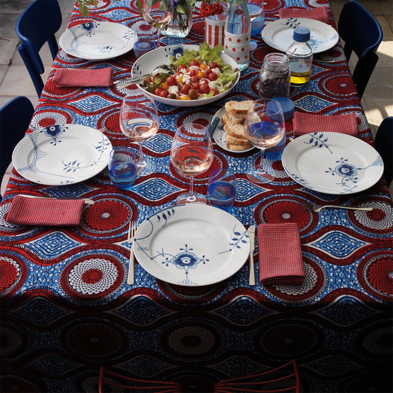 Royal Copenhagen | Blue Mega Plate, 27cm, Dec. No.6, set on a colorful dining table, surrounded by a casual meal setting for six.
