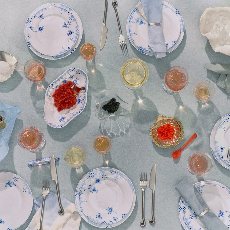 Royal Copenhagen Blue Elements Plate, 22cm, elegantly set with caviar and champagne, showcasing its intricate, hand-painted design in a refined dining setting.