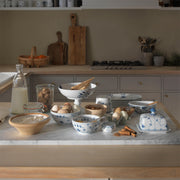 Royal Copenhagen | Blue Fluted Plain Butter Dish elegantly adorns a cozy kitchen island, surrounded by baking essentials, embodying timeless style and craftsmanship.