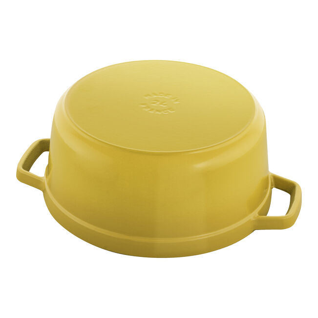Staub | Round Cocottes - 4 qt Citron, enameled cast-iron casserole pot, shown upside-down, highlighting its sturdy construction and dual handles for versatile cooking.