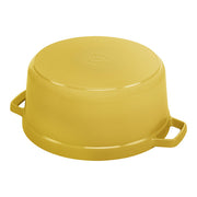 Staub | Round Cocottes - 7 qt Citron, enameled yellow cooking pot with side handles, shown upside-down, highlighting its smooth, flat bottom, ideal for even heat distribution.