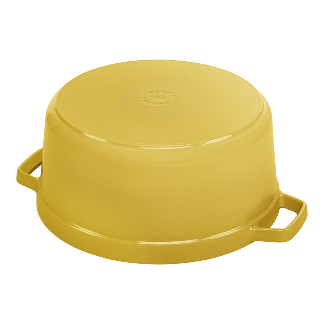 Staub | Round Cocottes - 7 qt Citron, enameled yellow cooking pot with side handles, shown upside-down, highlighting its smooth, flat bottom, ideal for even heat distribution.