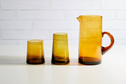 Moroccan Cone Glassware Large Amber - Set of 6: Hand-blown cone-shaped glasses with visible bubbles, crafted from recycled bottles, showcasing artisan skill. Ideal for beverages or as decorative vases.