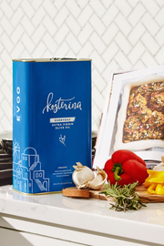 Kosterina - Organic Everyday Extra Virgin Olive Oil Tin (3L) next to fresh vegetables, ideal for cooking and baking needs.